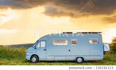 Sunset sky over caravan camping on nature. Sunset sky over caravan camping on nature. 136192123