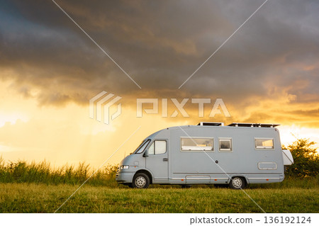 Sunset sky over caravan camping on nature. Sunset sky over caravan camping on nature. 136192124