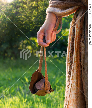 Man's hand with an old sling Man's hand with an old sling 136192321