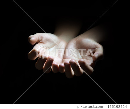 Asking hands on black backdrop 136192324