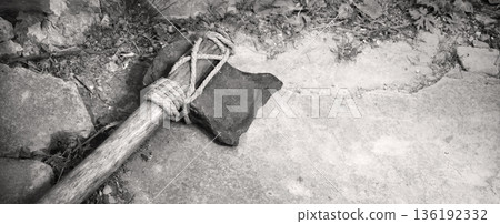Stone ax of a primitive man Stone ax of a primitive man 136192332