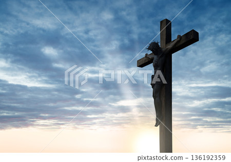 Crucified Christ hangs on the cross 136192359