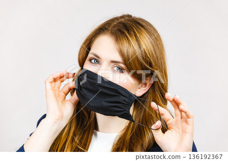 Female using protective face mask. 136192367