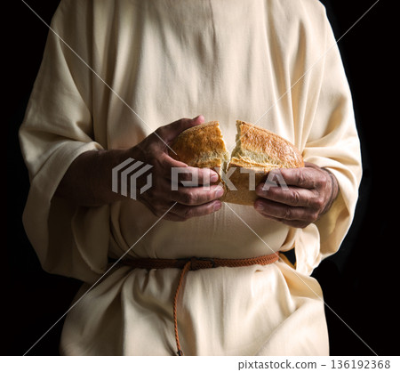 Man's hans holding fresh bread 136192368