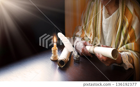 Man holding an old scroll Man holding an old scroll 136192377