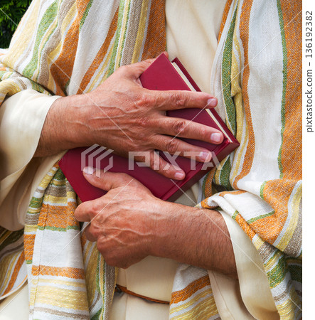 Old man holding red book Old man holding red book 136192382