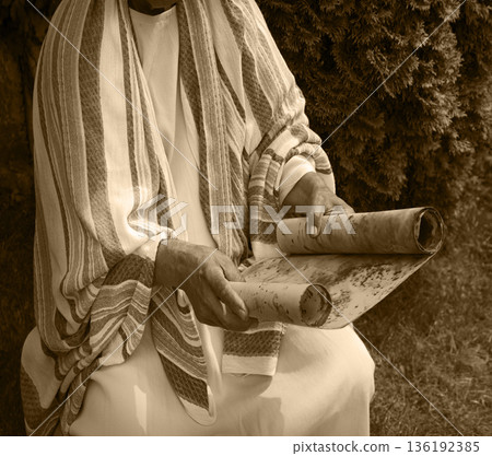Old man reading the scroll Old man reading the scroll 136192385