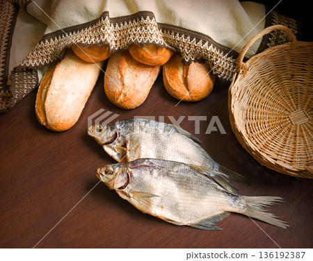 Bread and fish on the table 136192387