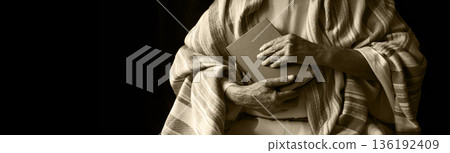 Old man holding a book Old man holding a book 136192409