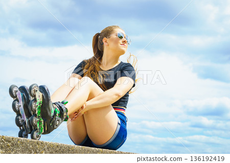 Fit girl with roller skates outdoor Fit girl with roller skates outdoor 136192419