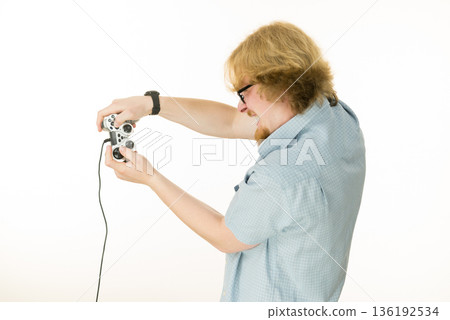 Gamer man holding gaming pad Gamer man holding gaming pad 136192534