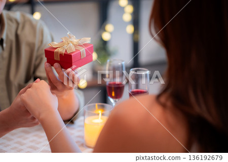 Romantic asian man giving gift box to girlfriend with excited, surprise for Valentine's Day. Romantic asian man giving gift box to girlfriend with excited, surprise for Valentine's Day. 136192679