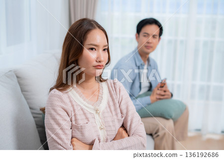 Angry asian couple sitting sofa with conflict and frustrated, woman ignoring boyfriend. Angry asian couple sitting sofa with conflict and frustrated, woman ignoring boyfriend. 136192686