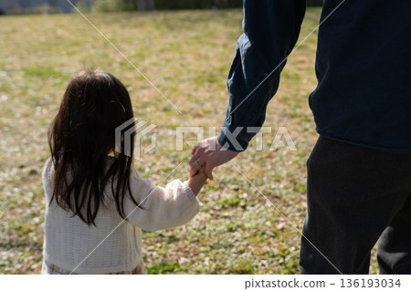 Girls holding hands with their fathers Girls holding hands with their fathers 136193034