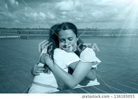 Two girls hugging in the cafe 136193055