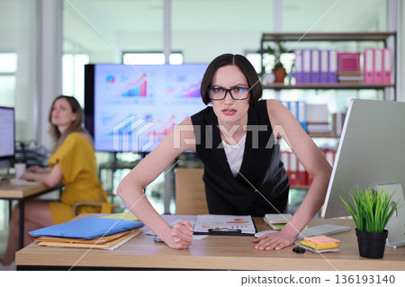 Frustration fills the modern workspace as professionals tackle challenging tasks during a busy day 136193140