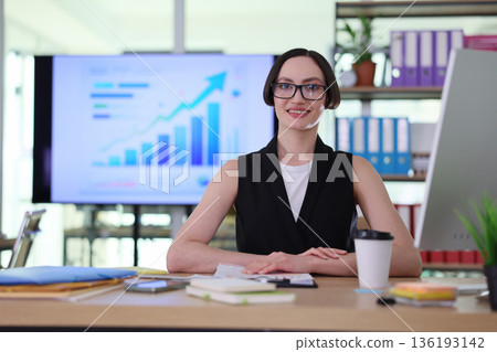 Business professional confidently presenting data insights in a bright office environment 136193142