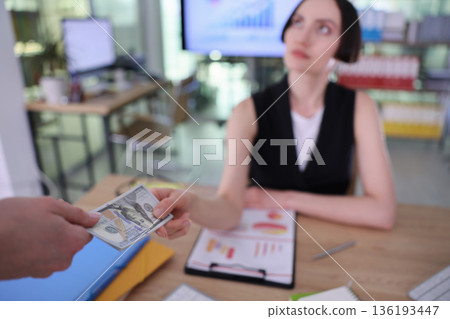 Business meeting in a modern office with a financial exchange and focus on negotiation dynamics 136193447