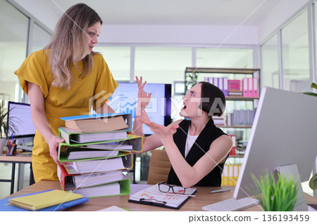 Office tension rises as colleagues argue over piled paperwork during a hectic afternoon meeting Office tension rises as colleagues argue over piled paperwork during a hectic afternoon meeting 136193459