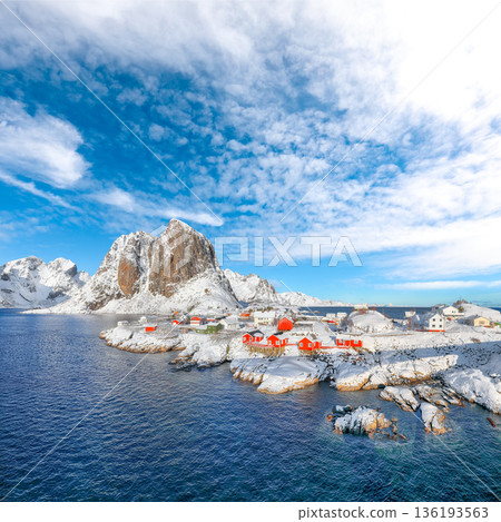 Outstanding winter view on Hamnoy village and Festhaeltinden mountain on background. Outstanding winter view on Hamnoy village and Festhaeltinden mountain on background. 136193563