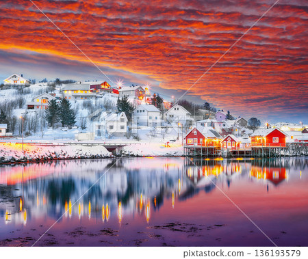 Outstanding evening cityscape of Reine town. Red rorbuers on the shoore of Reinefjorden. 136193579