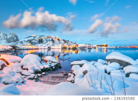 Outstanding evening cityscape of Reine town. Red rorbuers on the shoore of Reinefjorden. 136193580