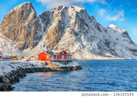 Outstanding view on Traditional Norwegian red wooden houses on the shore of Reinefjorden on Toppoya island. Outstanding view on Traditional Norwegian red wooden houses on the shore of Reinefjorden on Toppoya island. 136193593