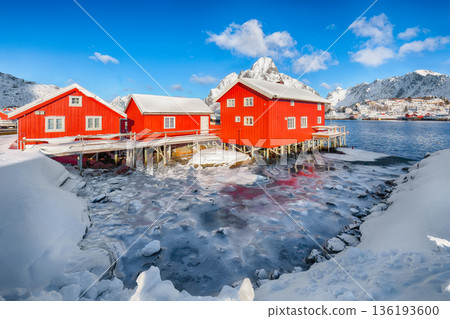 Outstanding winter sunny view on Reine Village and Gravdalbukta bay with cracked ice. 136193600