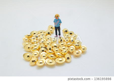 Miniature Figure Standing Proudly Atop Pile Of Gold Miniature Figure Standing Proudly Atop Pile Of Gold 136193898