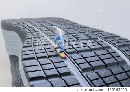 Miniature Skateboarder Riding Down Ridge Of Giant Shoe Miniature Skateboarder Riding Down Ridge Of Giant Shoe 136193913