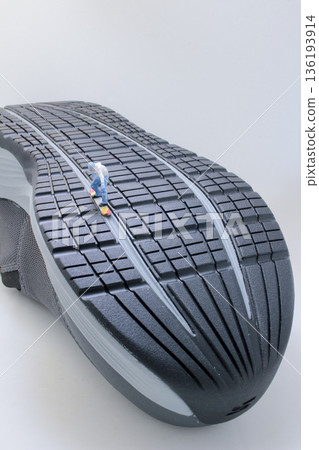 Miniature Skateboarder Riding Down Ridge Of Giant Shoe Miniature Skateboarder Riding Down Ridge Of Giant Shoe 136193914