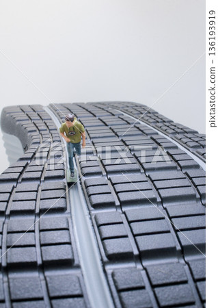 Miniature Kayaker Sliding Swiftly Down Giant Shoe Sole 136193919