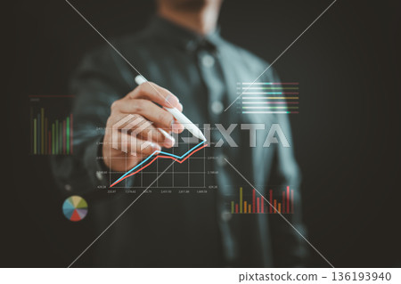 Businessman Drawing Financial Growth Chart with Digital Pen on Transparent Screen 136193940