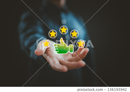 Businessman holding five star rating with thumbs up icon for customer review and positive feedback 136193942