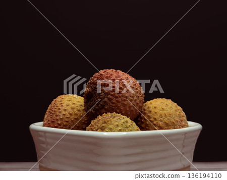 Fresh Lychee Fruit in White Bowl Close Up Exotic Tropical Food Still Life on Dark Background 136194110