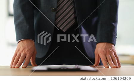 Business professional confidently presenting ideas in an office setting during a collaborative meeting 136194209