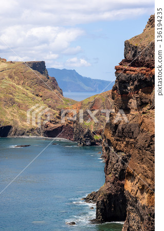 Vertical coastal landscape of Baia d Abra Point of Saint Lawrence with volcanic cliffs and sea 136194235