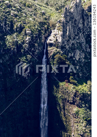 Vertical view of Garganta Funda cascade cutting narrow chasm near Ponta do Pargo Madeira Portugal 136194243