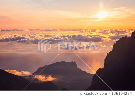 Sunrise over Atlantic cloud sea from Pico do Arieiro with golden light and drifting clouds sky 136194254