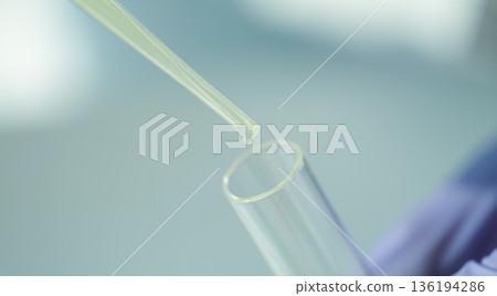 Precision in action as liquid fills test tube during scientific experimentation in a bright laboratory setting 136194286