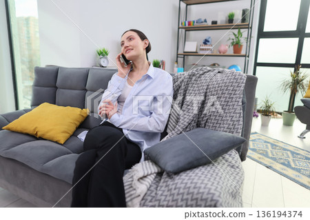 Engaging conversation in a modern living room during a bright afternoon Engaging conversation in a modern living room during a bright afternoon 136194374