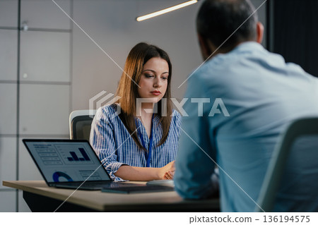 Young businesswoman attending job interview with male recruiter 136194575