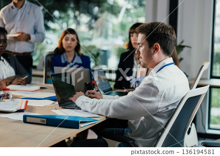 Business people collaborating during busy corporate meeting Business people collaborating during busy corporate meeting 136194581