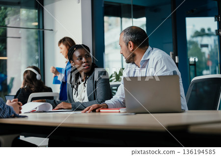 Business professionals collaborating in modern office meeting 136194585