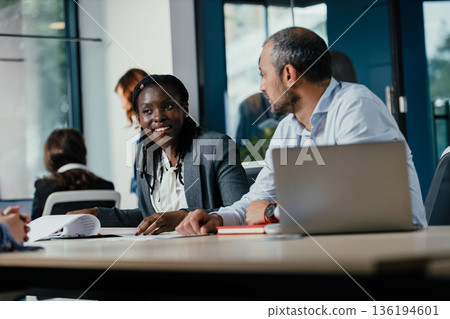 Diverse business professionals collaborating in an office meeting Diverse business professionals collaborating in an office meeting 136194601