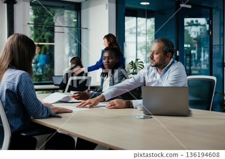 Diverse business team collaborating during an office meeting 136194608