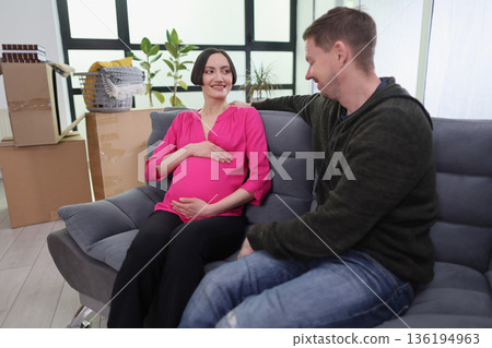 Couple shares joyful moments together as they prepare for the arrival of their baby in a cozy new home Couple shares joyful moments together as they prepare for the arrival of their baby in a cozy new home 136194963