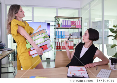 Busy office scene with two coworkers engaging in a discussion about workloads and productivity techniques during a sunny afternoon 136195055