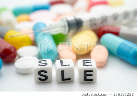 SLE systemic Lupus erythematosus or Lupus word with pills and capsules medical drug. 136195228
