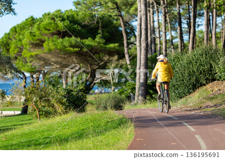 Person riding a bicycle on a cycle path Person riding a bicycle on a cycle path 136195691